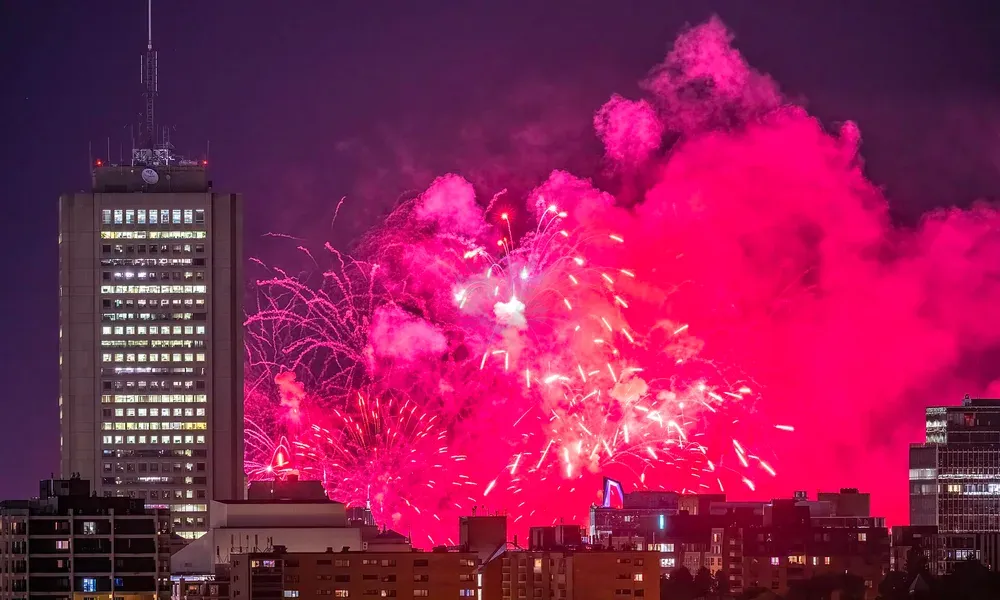 Fireworks over a city skyline at night